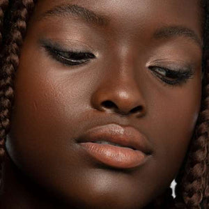 Beautiful Black model close up of face makeup with a natural look for dark skin tones